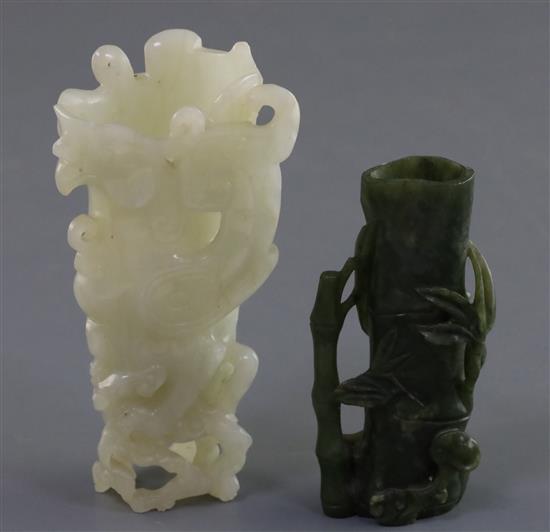 A Chinese archaistic white jade rhyton and a spinach green jade vase, 18th/19th century, H. 11cm and 8.5cm